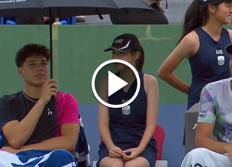 Shelton Offers Umbrella To A Ball Girl Shelton Offers Umbrella To A Ball Girl