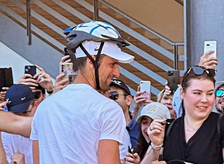 Hilarious Djokovic wears bike helmet while signing autographs