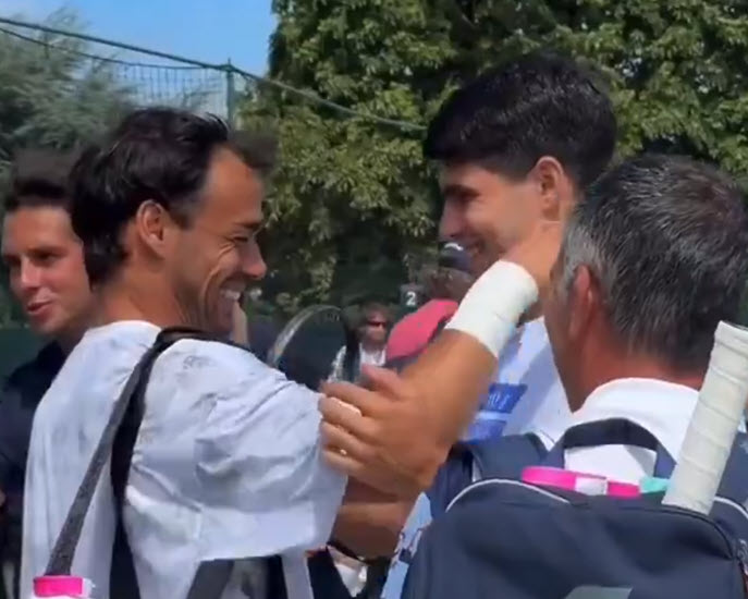 Carlos Alcaraz and Fabio Fognini share a warm embrace after discovering their Wimbledon first-round matchup
